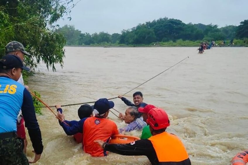 A handout photo taken on September 14 from the Philippine Coast Guard shows rescue workers