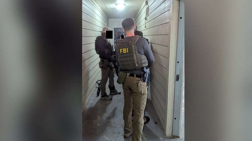 FBI agents arresting gang members