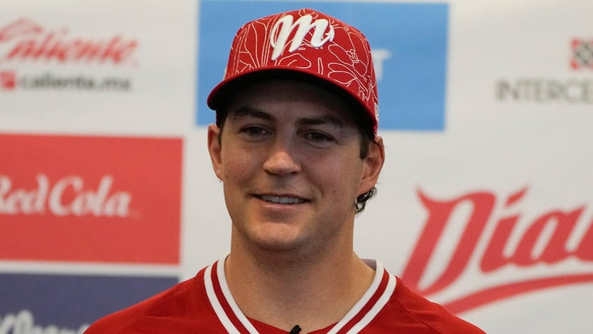 Trevor Bauer smiles with Diablos Mexico jersey