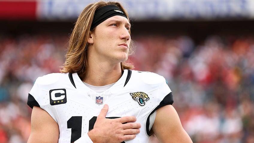 Trevor Lawrence stands during the anthem