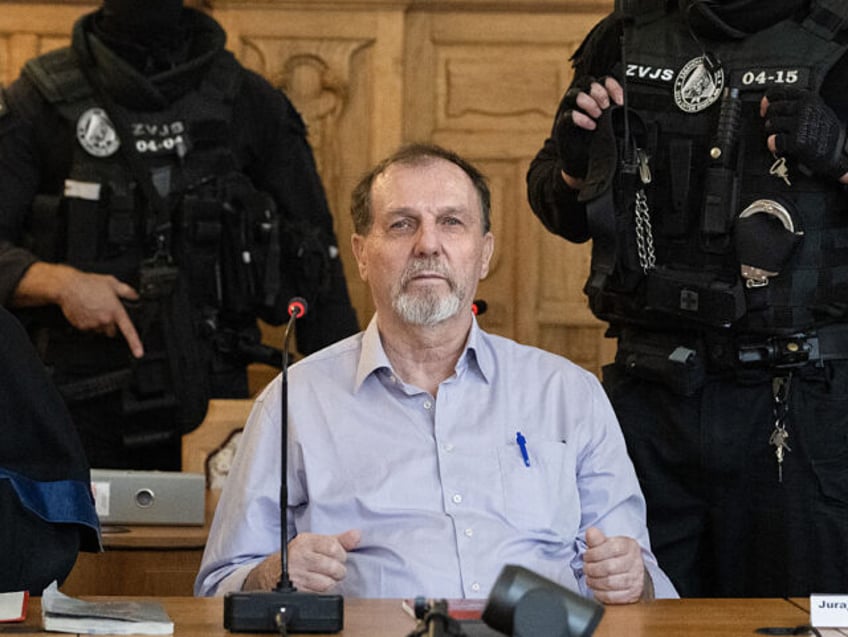 TOPSHOT - Defendant Juraj Cintula, a 72-year-old poet, sits guarded by two police officers