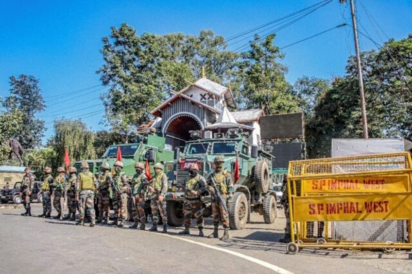 Army personnel stand guard Tuesday during a curfew in Imphal, in India's northeastern stat