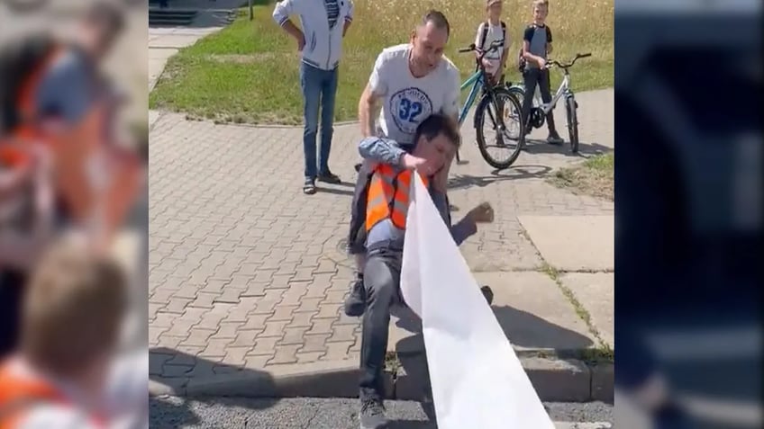 trucker in germany drags radical climate protester with vehicle during brutal confrontation