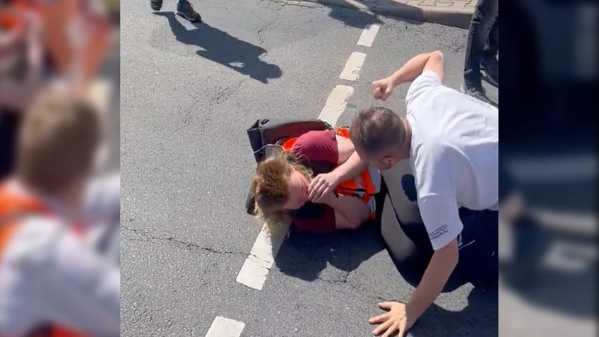trucker in germany drags radical climate protester with vehicle during brutal confrontation