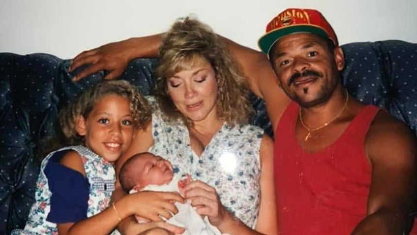 Madison McGhee posing with her family in a candid home shot