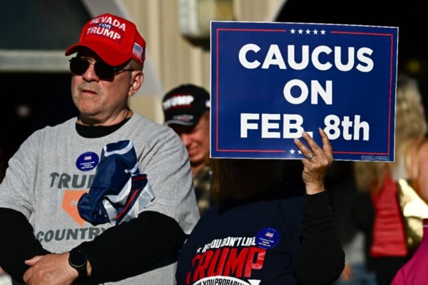 Supporters of former US president and 2024 presidential hopeful Donald Trump watch his speech on an screen outside a Commit to Caucus Rally in Las Vegas, Nevada, on January 27, 2024