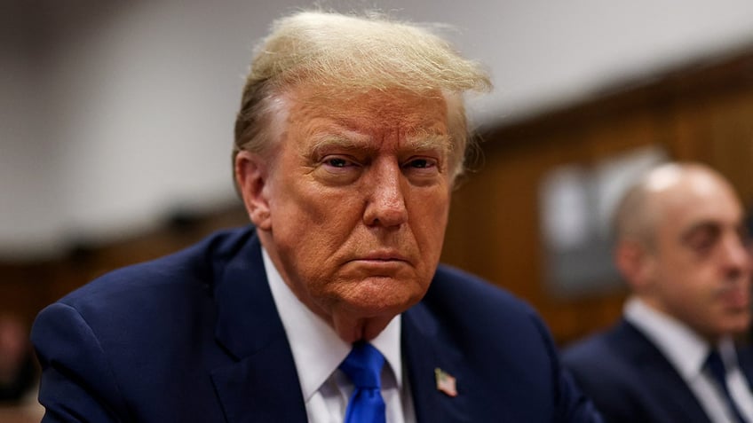 Donald Trump sits in the courtroom for the first day of opening arguments in his Manhattan criminal trial.