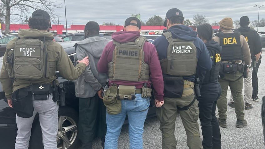 Federal agents detain a man accused of immigration crime