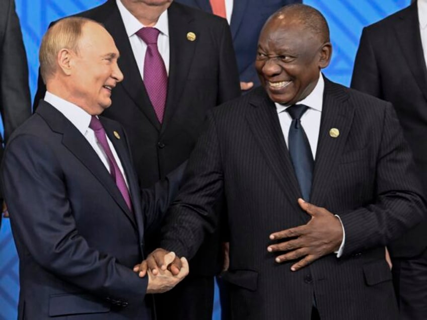 Russian President Vladimir Putin, left, and South African President Cyril Ramaphosa shake