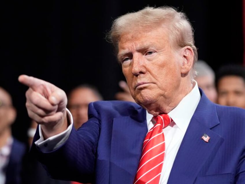 President Donald Trump pumps his fist after speaking during a campaign rally at the Huntin