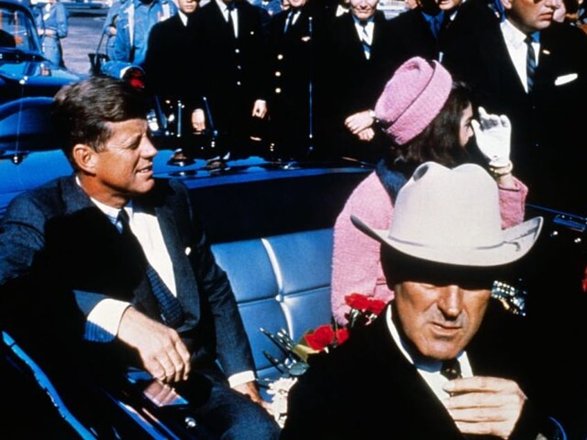 US President John F Kennedy (left), First Lady Jacqueline Kennedy (in pink), and Texas Gov