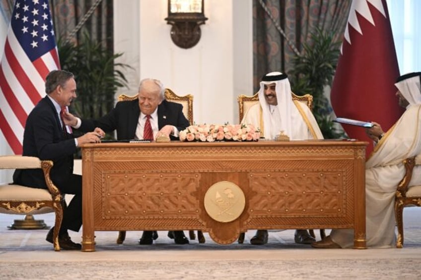 Boeing CEO Kelly Ortberg sits to the left of US President Donald Trump and Qatar's Emir Sh
