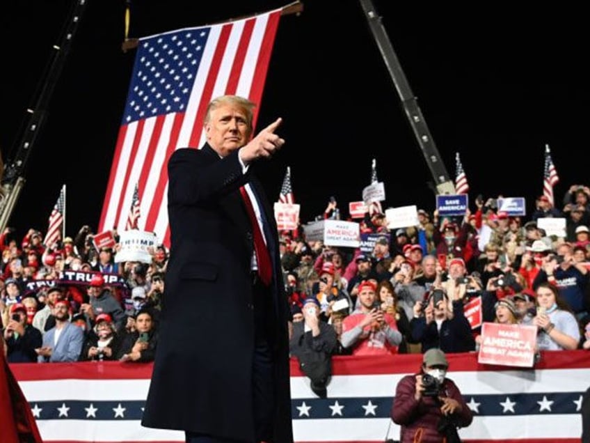 US President Donald Trump walks with First Lady Melania Trump at the end of a rally to support Republican Senate candidates at Valdosta Regional Airport in Valdosta, Georgia on December 5, 2020. - President Donald Trump ventures out of Washington on Saturday for his first political appearance since his election …