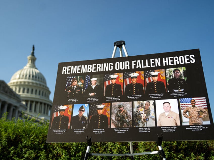 WASHINGTON, DC - SEPTEMBER 9: A sign displaying photos and names of the 13 service members