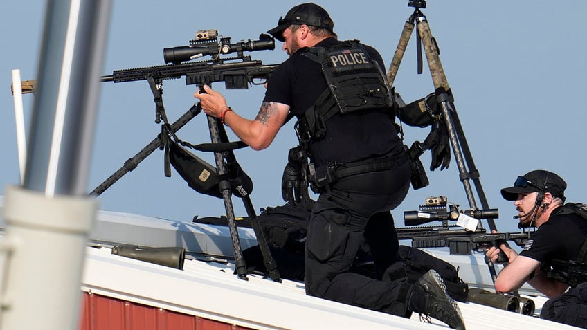 Police snipers return fire after shots were fired while Republican presidential candidate former President Donald Trump was speaking at a campaign event