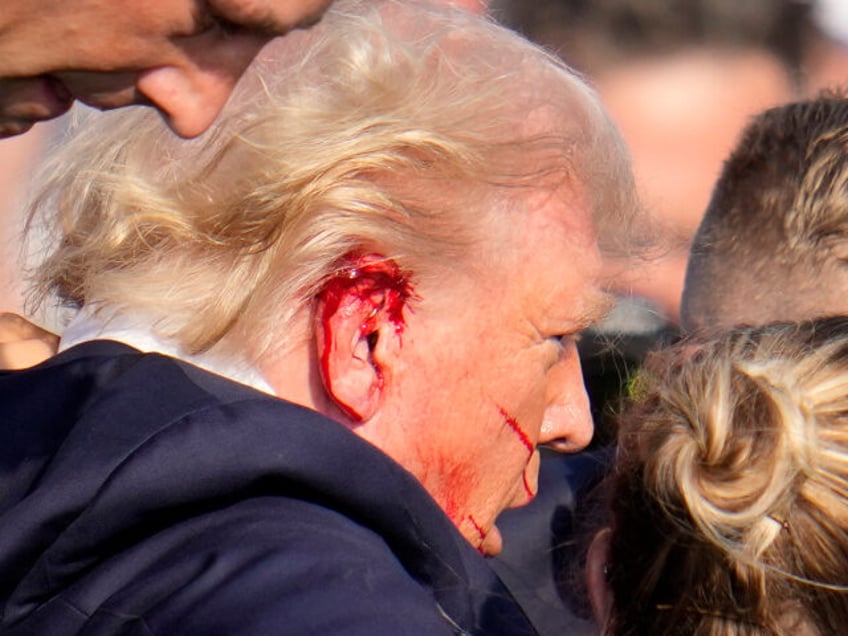 Republican presidential candidate former President Donald Trump is escorted to a motorcade