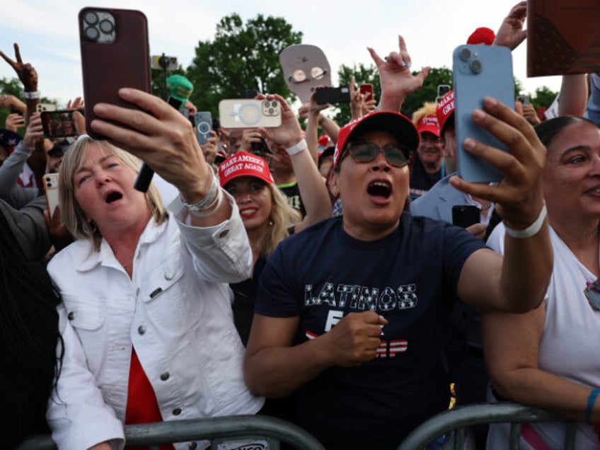 Supporters of former President Donald Trump watch as he holds a rally in the historical De