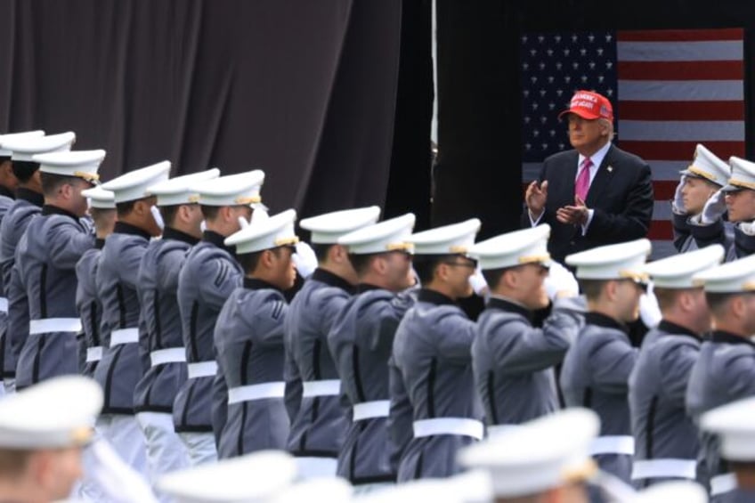US President Donald Trump delivers a highly political speech to graduating officers at the