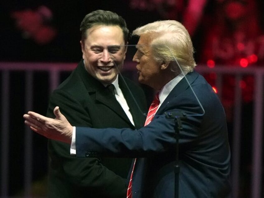 Elon Musk, with his son X Æ A-Xii, arrives on the dais with President-elect Donald Trump,