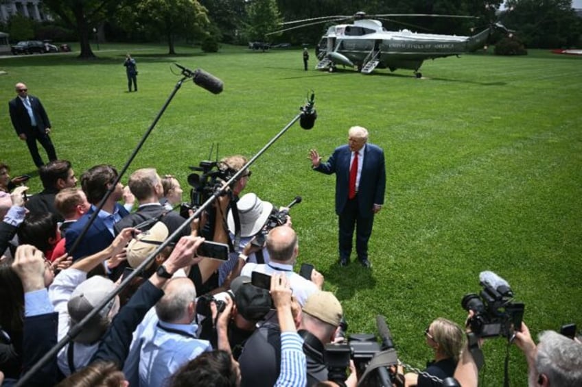 US President Donald Trump speaks with reporters on the South Lawn of the White House in Wa