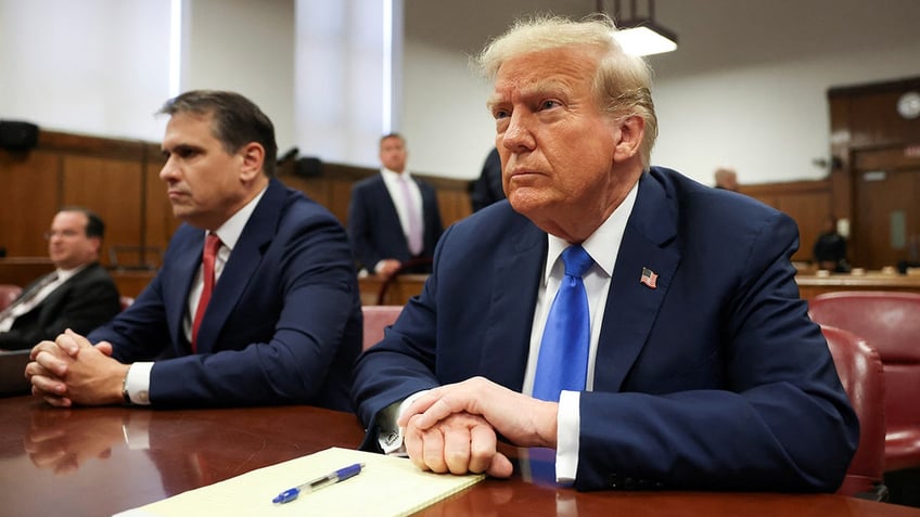 Donald Trump sits in the courtroom for the first day of opening arguments in his Manhattan criminal trial.