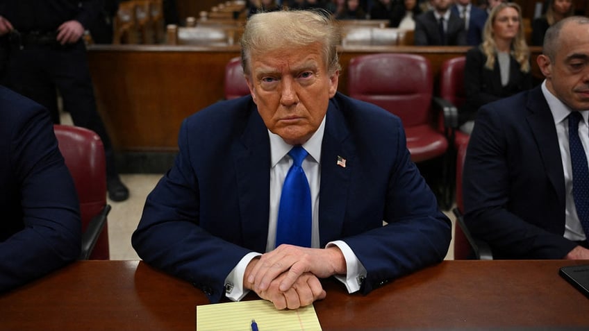 Donald Trump sits in the courtroom for the first day of opening arguments in his Manhattan criminal trial.