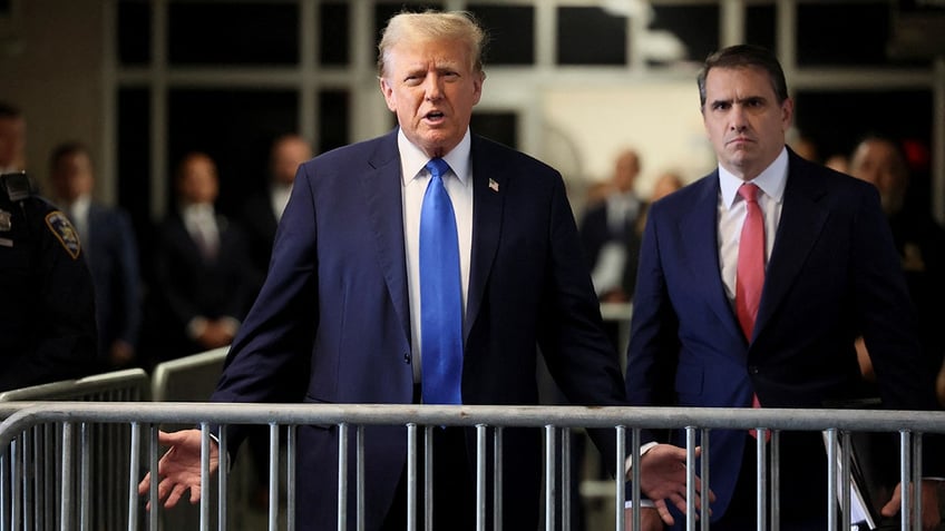 Donald Trump speaks to the media while entering his Manhattan criminal trial