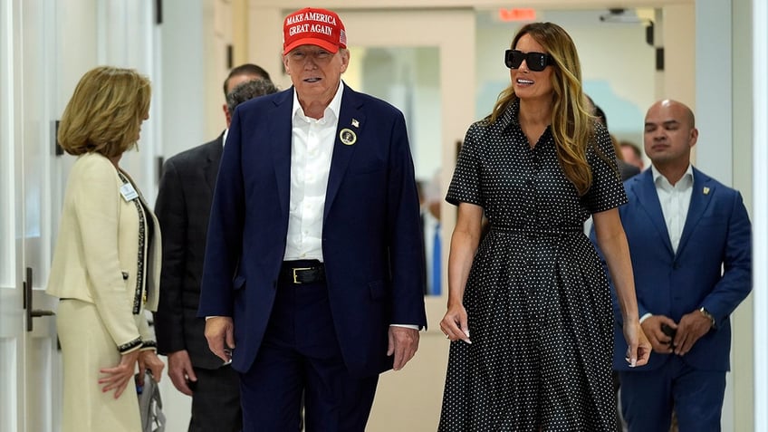 Donald Trump and Melania Trump walk after voting on Election Day