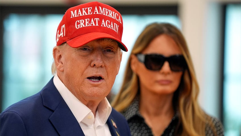 Donald Trump and Melania Trump walk after voting on Election Day