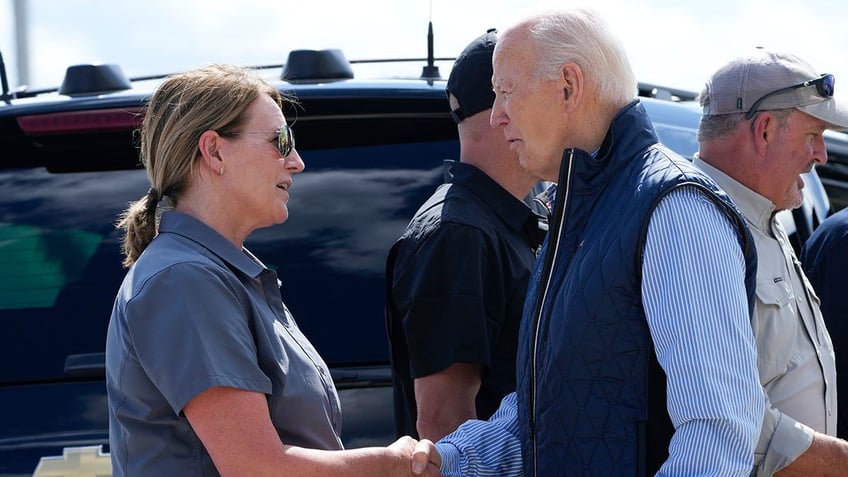 President Joe Biden talks with FEMA Director Deanne Criswell