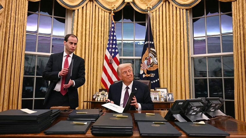 President Donald Trump signs executive orders at the White House