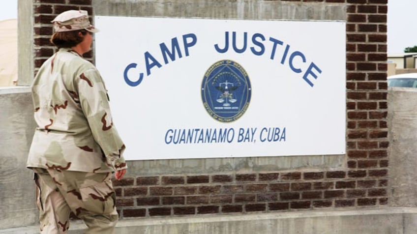 Aug. 8: A U.S. Navy personnel is seen walking past a monument at Camp Justice, site of the military commission courthouse where Canadian citizen Omar Khadr is set to be tried for war crimes at Guantanamo Bay, Cuba.