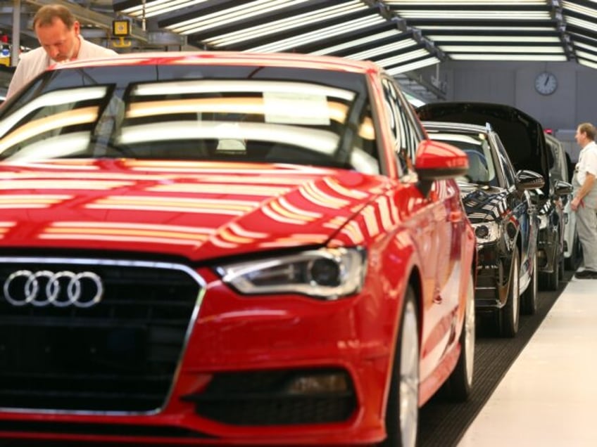 INGOLSTADT, GERMANY - MARCH 11: An Audi employee carries out the final inspection on a row