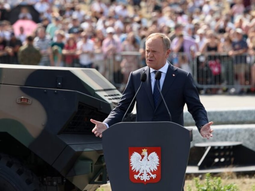 Poland's Prime Minister Donald Tusk is gesturing during his speech as he is taking part in