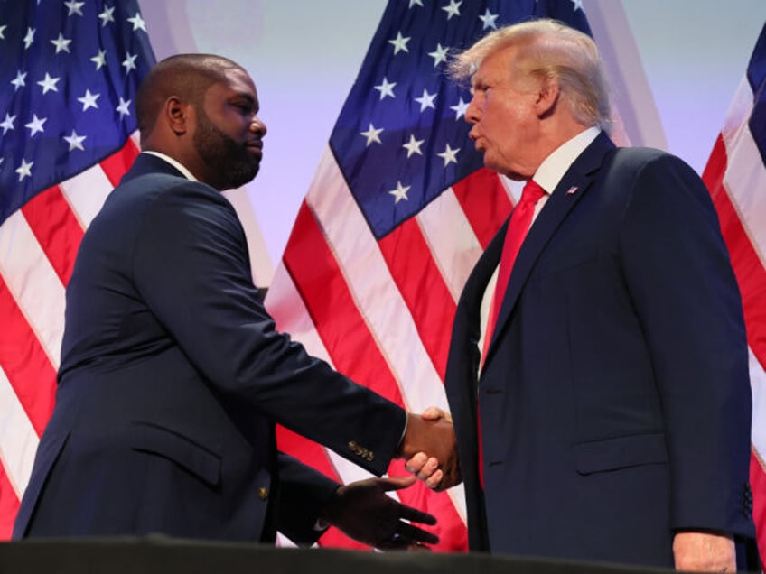 Rep. Byron Donalds (R-FL) shakes hands with former U.S. President Donald Trump during the