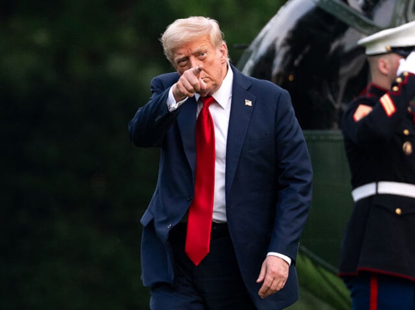 US President Donald Trump walks on the South Lawn of the White House after arriving on Mar