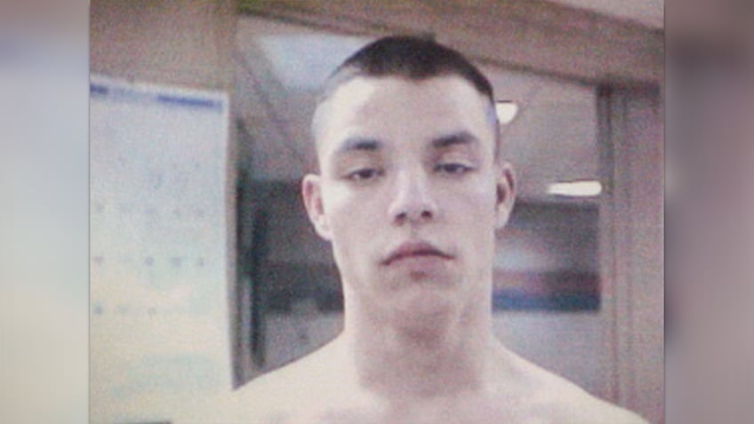 brandon basham with buzzed hair and shirtless in prison photo