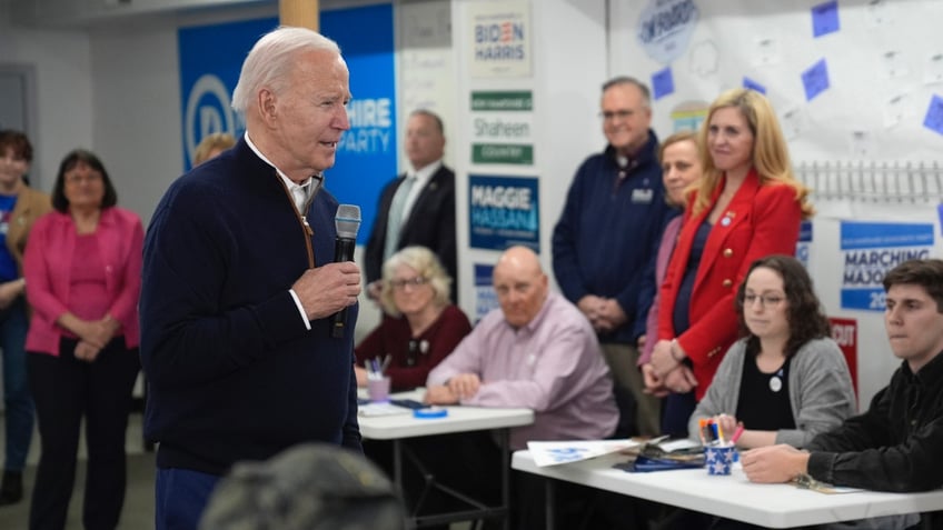 President Biden holding microphone