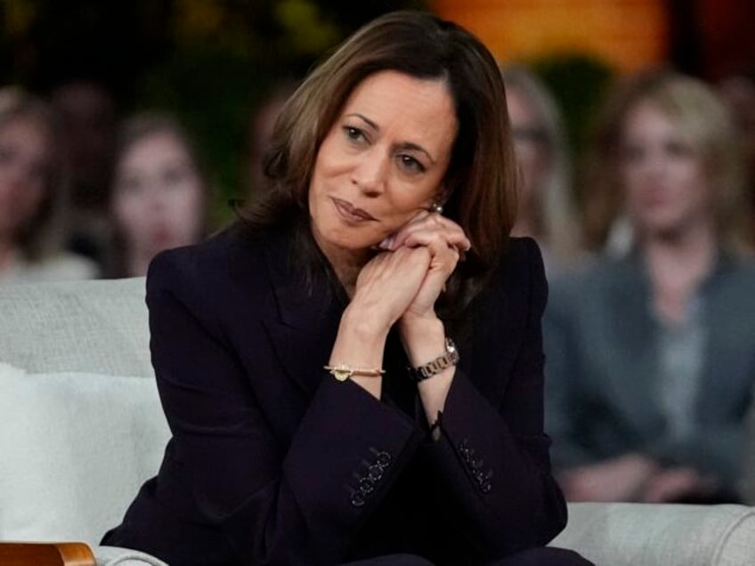 Democratic presidential nominee Vice President Kamala Harris listens to a parent's su