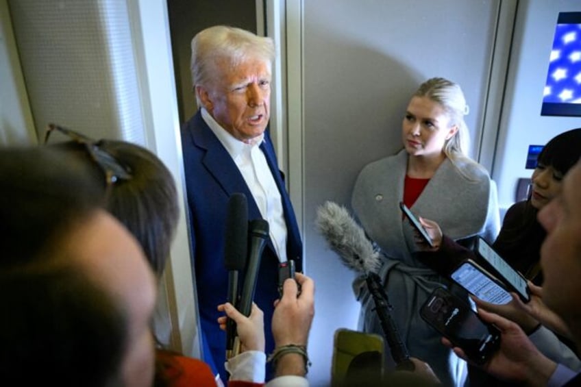 US President Donald Trump speaks with the press, alongside White House Press Secretary Kar