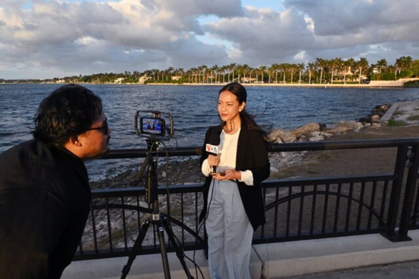 A crew from Voice of America make a live report near Donald Trump's Mar-a-Lago estate in F