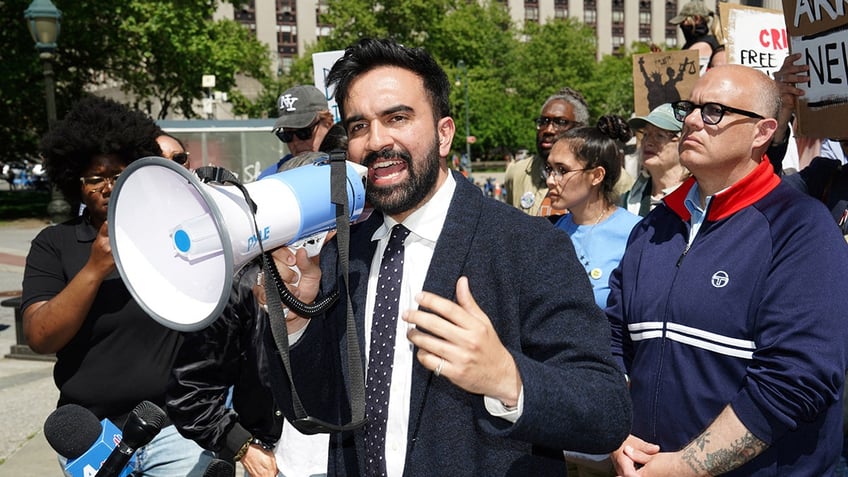 Zohran Mamdani speaking into bullhorn 