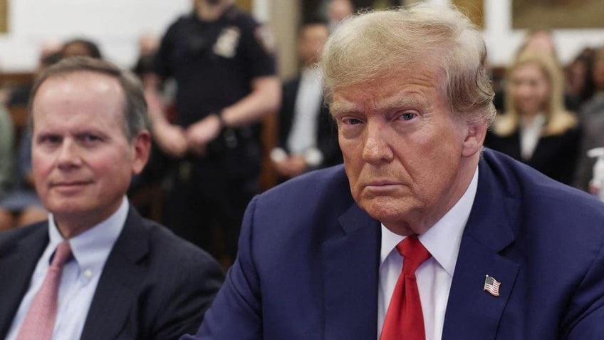 Former US President Donald Trump sits at the New York State Supreme Court