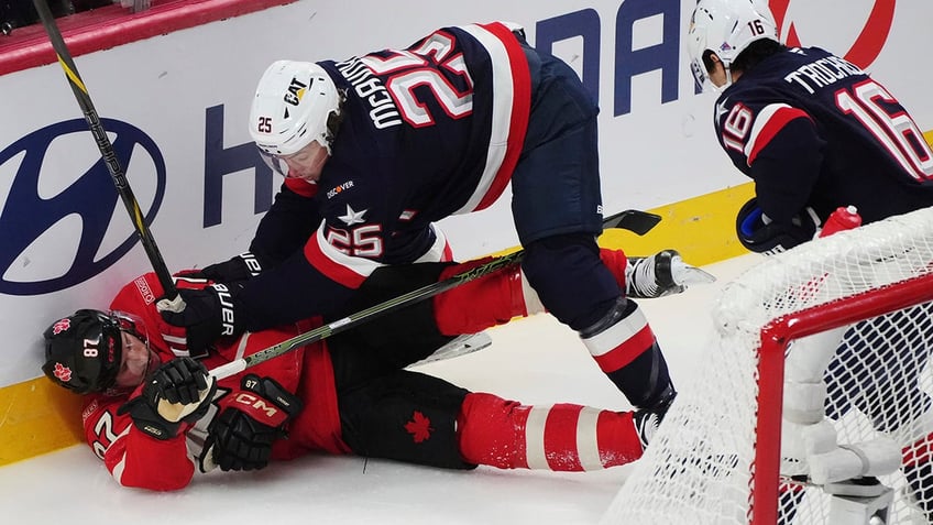 Charlie McAvoy checks Sidney Crosby