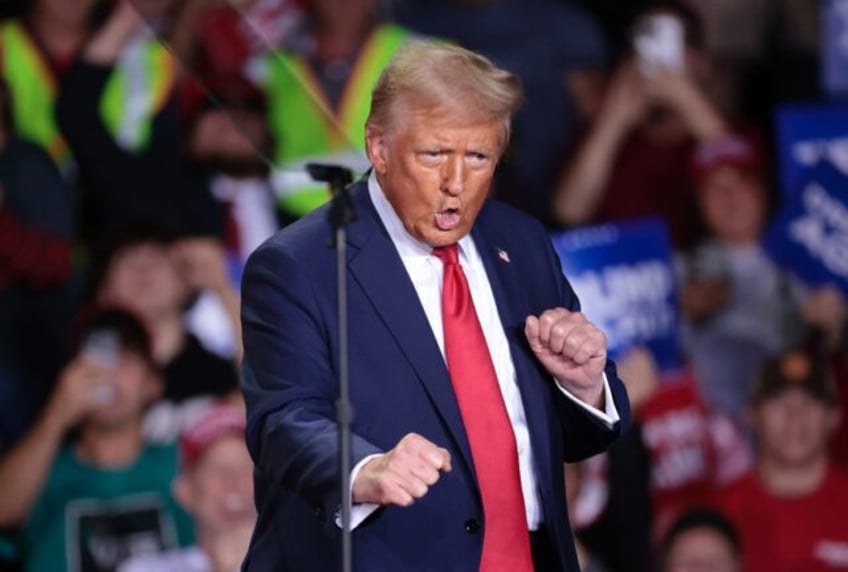 Former US President and Republican presidential candidate Donald Trump dances as he arrive