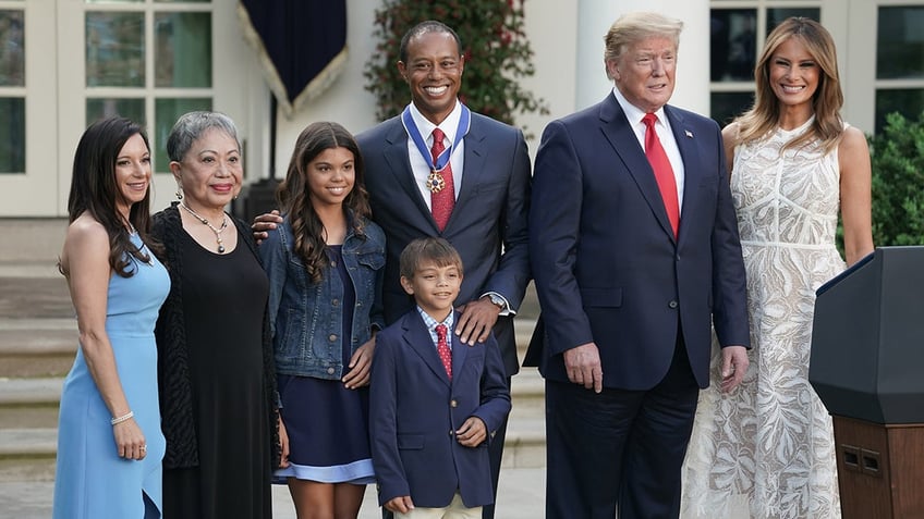 Tiger Woods poses with family and President Donald Trump