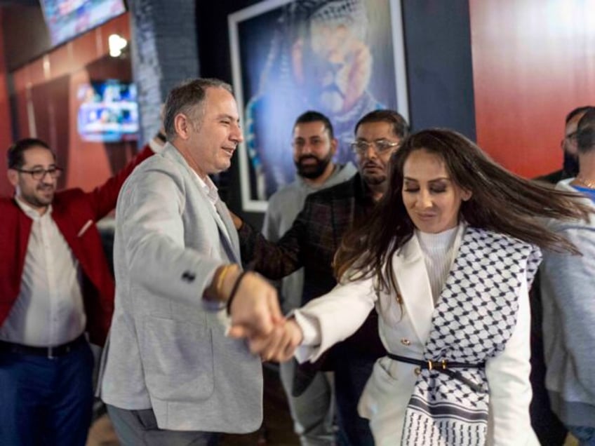 Wasel Yousaf, left, dances with Mona Salama, as they celebrate during an Arab Americans fo