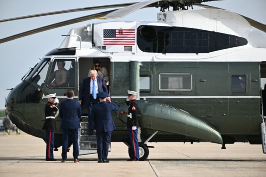 US President Donald Trump and First Lady Melania Trump step off Marine One upon arrival at