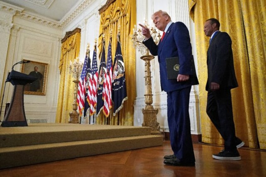 US President Donald Trump and US golfer Tiger Woods spoke during a reception for Black His