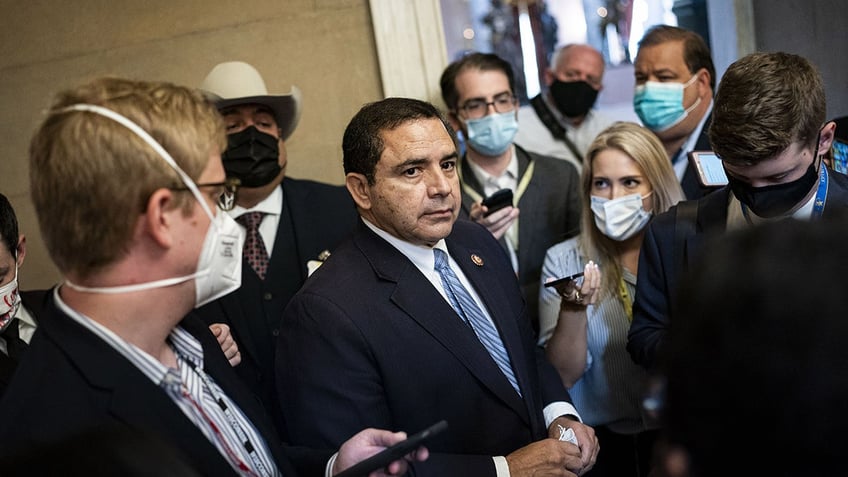 Henry Cuellar in Capitol hallway surrounded by press